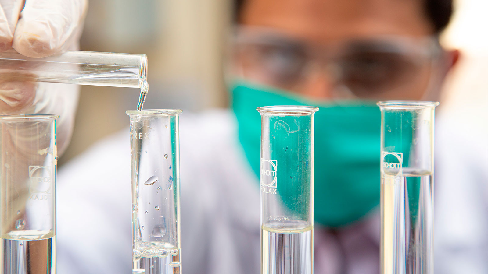 Man carefully measuring chemicals