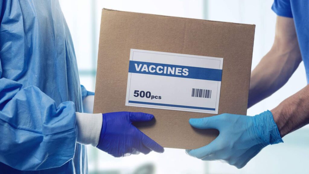 vaccine shipping box being passed between two people